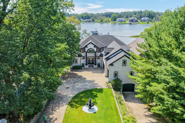 Aerial view of the estate's private drive, fountain courtyard and the lake beyond