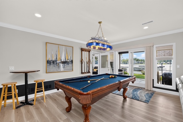 The billiard room with full-size table, pub seating and doors onto the lakefront patio