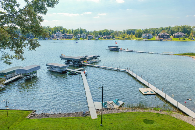 Aerial view of the estate's private docks, boat lifts and the open water of Long Lake