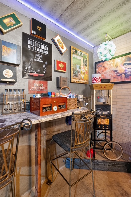 The cigar room with humidor, tasting bar and framed cigar art