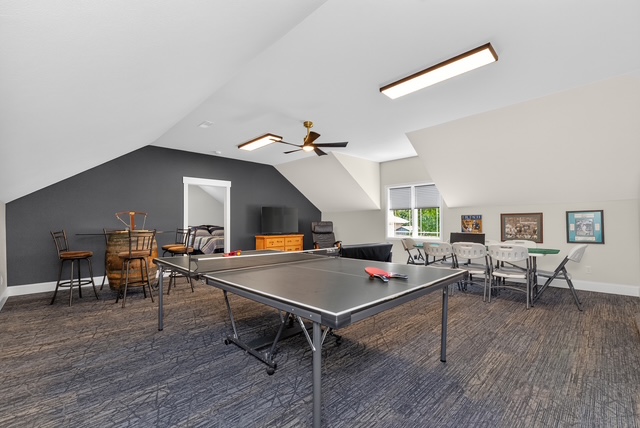 The vaulted game loft with ping pong table, pub bar and card tables